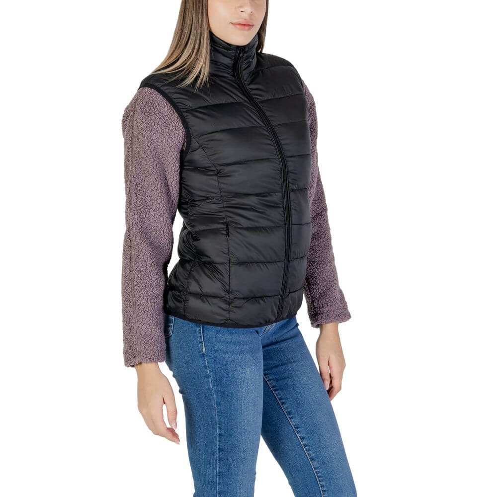 Woman wearing B.Young Black Nylon Sleveless Jacket with purple sleeves, showcasing quilted design and front zip closure for style and warmth.