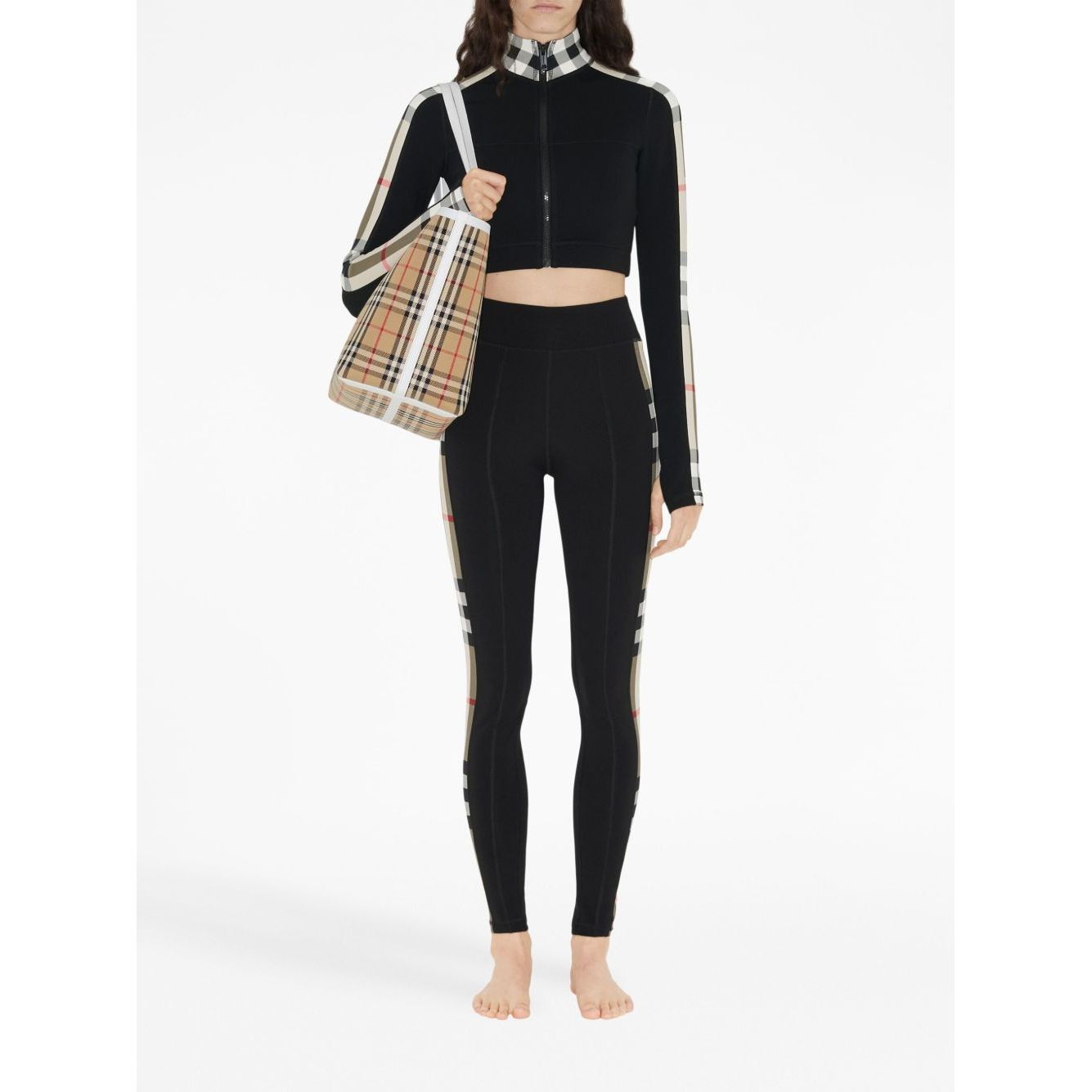 Woman wearing Burberry Stretch jersey leggings with Check finishes, featuring black stretch-jersey and Vintage Check pattern details.
