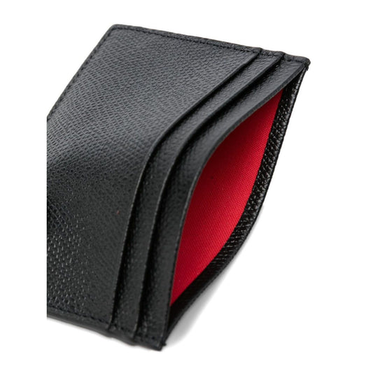 Close-up of black grained leather Christian Louboutin Mooncrest leather card case with red interior and embossed logo.