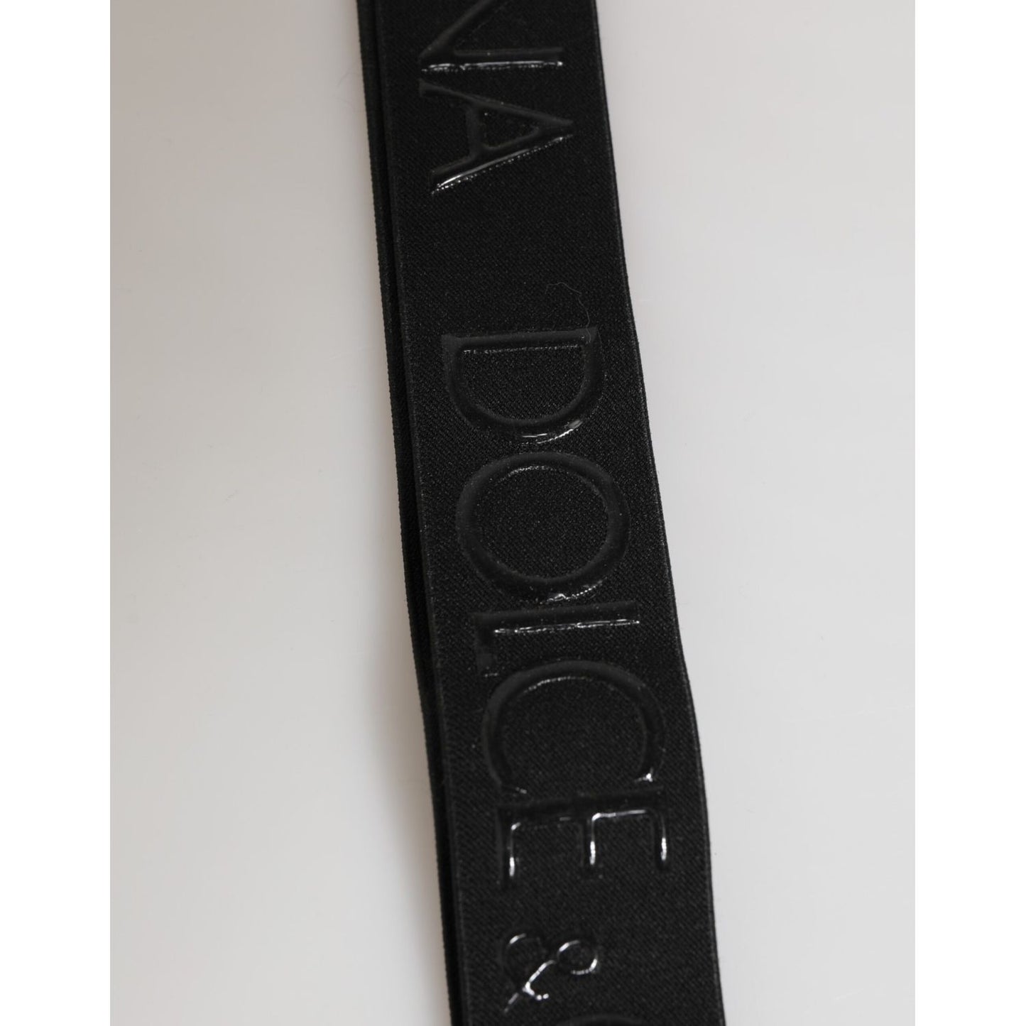 Detail of Dolce & Gabbana Black Polyester Stretch Rubberised DG Logo Men Keychain showing embossed logo on strap.