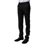 Model wearing Dolce & Gabbana Black Wool Formal Men Slim Pants, featuring virgin wool fabric and classic zipper closure, side view.