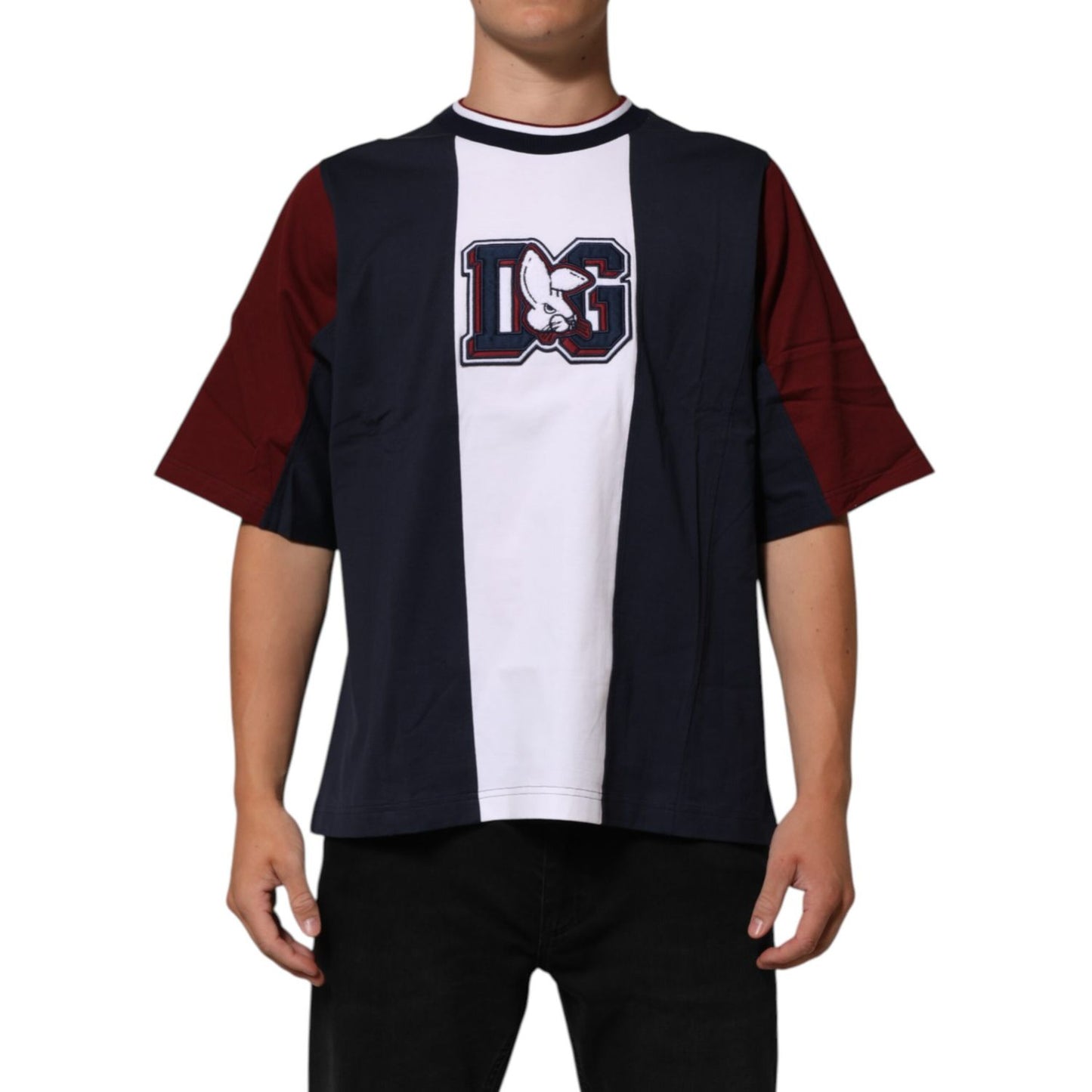 Man wearing a Dolce & Gabbana Multicolor Striped Cotton Men Crew Neck T-shirt with short sleeves, showcasing bold design.