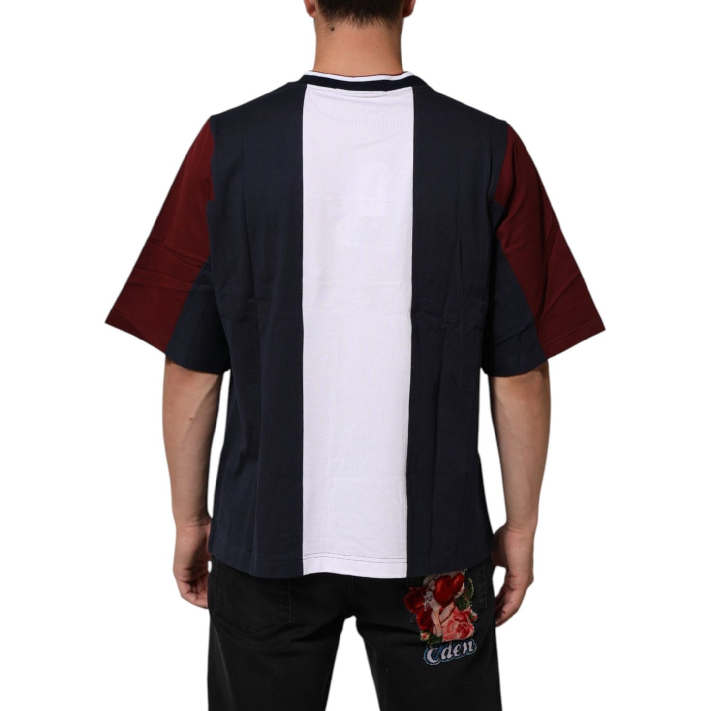 Man wearing Dolce & Gabbana Multicolor Striped Cotton Men Crew Neck T-shirt, showcasing back view with bold stripes, casual fashion.
