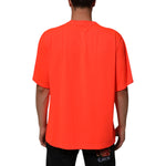 Back view of a Dolce & Gabbana Neon Orange Polyester Men Crew Neck T-shirt worn by a male model.