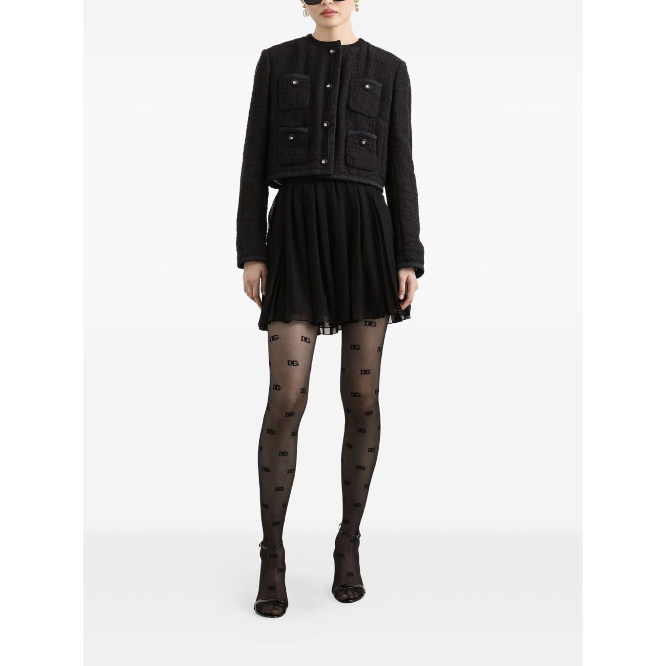 Model wearing Dolce & Gabbana Rachel Tweed Jacket, black with front button fastening, crew neck, four patch pockets, and buttoned cuffs.