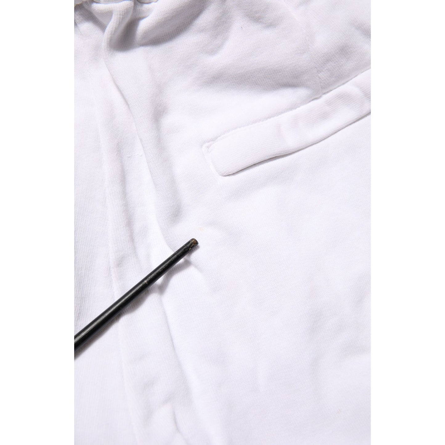 Close-up of Dolce & Gabbana White Cotton Cargo Trousers Logo Patch Pants detailing and fabric texture.