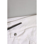 Close-up of Dolce & Gabbana White Cotton Tattered BOYFRIEND Denim Jeans showcasing button and fabric details.
