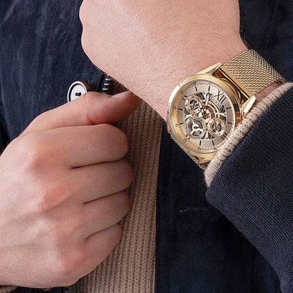 GUESS Mod. TAILOR gold watch on wrist, elegant and stylish design, close-up view.
