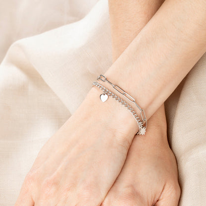 Close-up of a wrist wearing a delicate bracelet set from LOTUS JEWELS JEWELRY Mod. LS2313-2/1, featuring heart and star charms.
