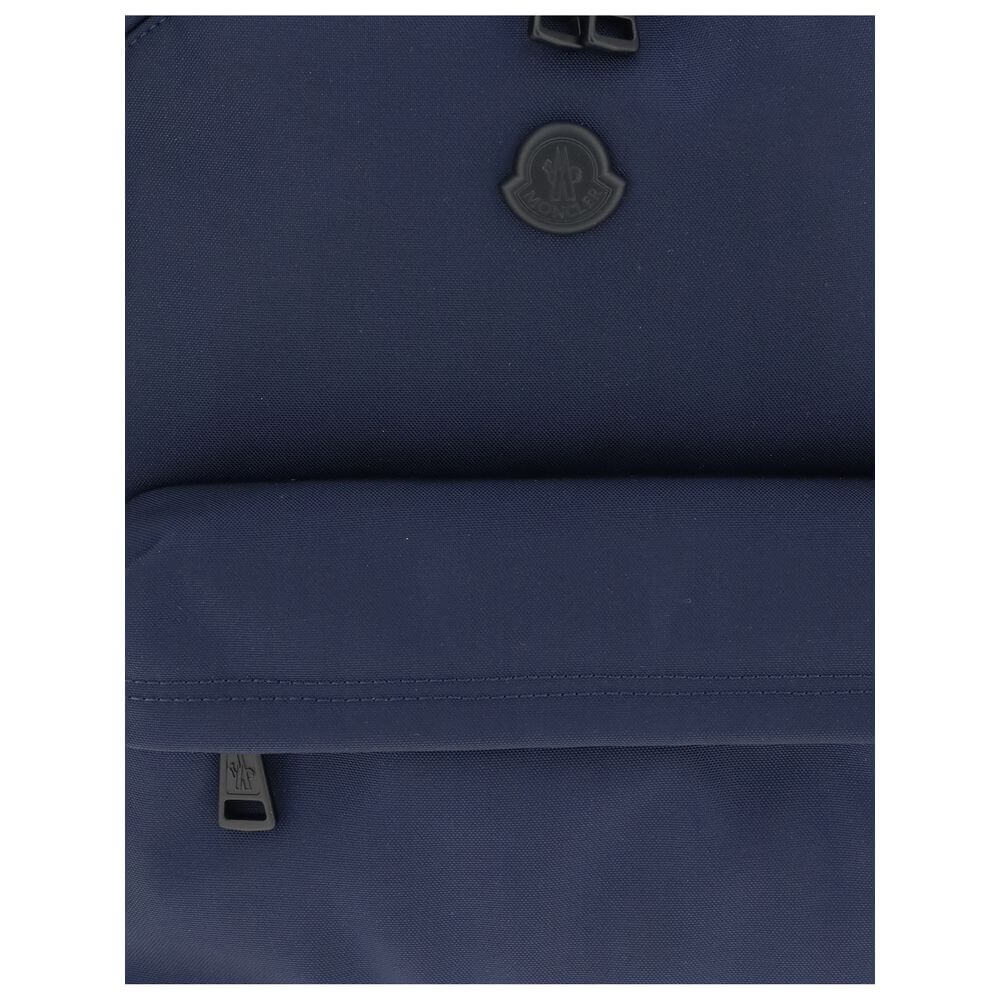 Close-up of Moncler Blue Nylon Backpack with logo and zipper, highlighting water-repellent fabric and leather trim for elegance.