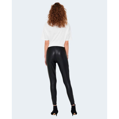 Rear view of woman wearing Only Black Polyester Leggings with glossy finish, highlighting sleek, elegant style.