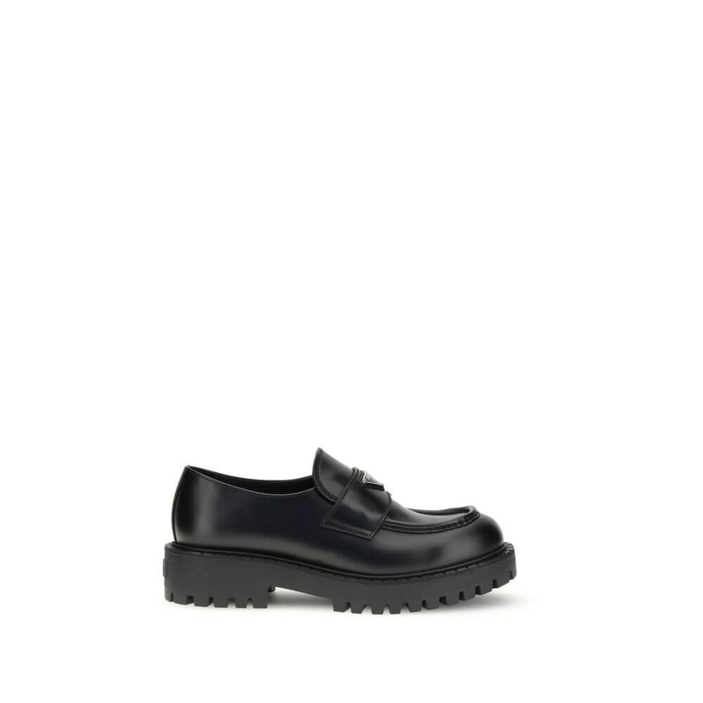 Prada Black Calf Leather Bos Taurus Slip-On Loafers with enameled metal triangle and rubber sole, made in Italy.
