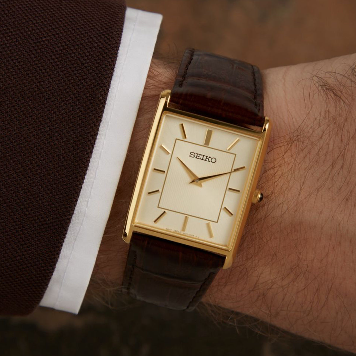 SEIKO WATCHES Mod. SWR064P1 on wrist, showcasing gold rectangular watch face and brown leather strap