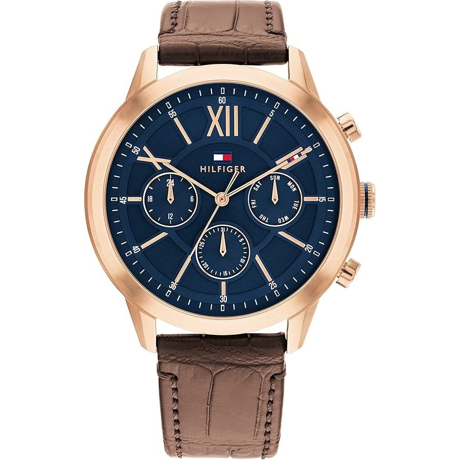 TOMMY HILFIGER Mod. 1710526 men's quartz analog watch with brown leather bracelet, 44mm mineral dial, gold-tone case, and official packaging.