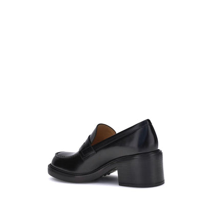 "Side view of Tod's Black Calf Leather Bos Taurus Platform Loafers with chunky heel, elegant and versatile design, made in Italy."