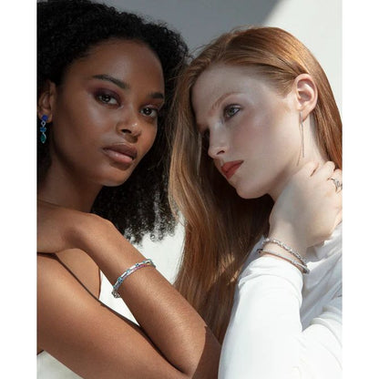 Two women wearing elegant VICEROY JEWELS Mod. 2326P000-30 silver bracelets showcasing modern fashion and style.