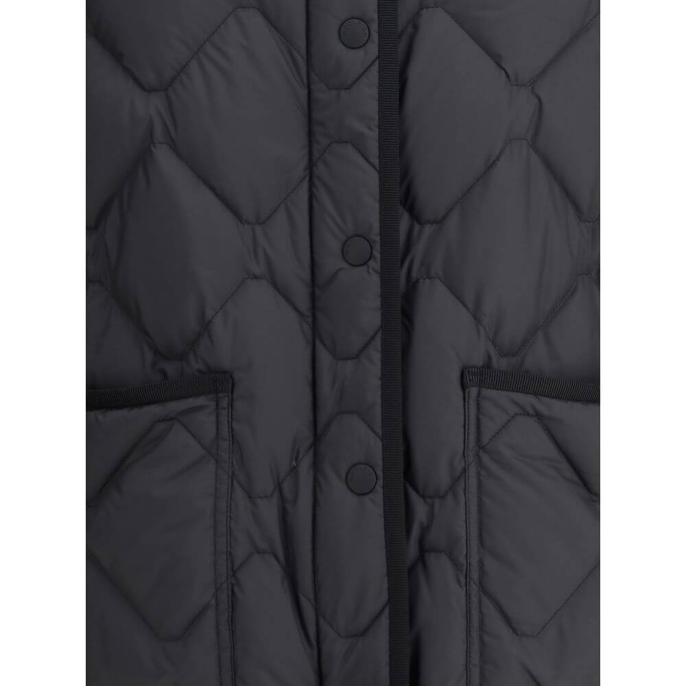 Close-up of Woolrich Black Polyester Clothing with front snap closure and patch pockets, showcasing quilted padded design for cold weather.